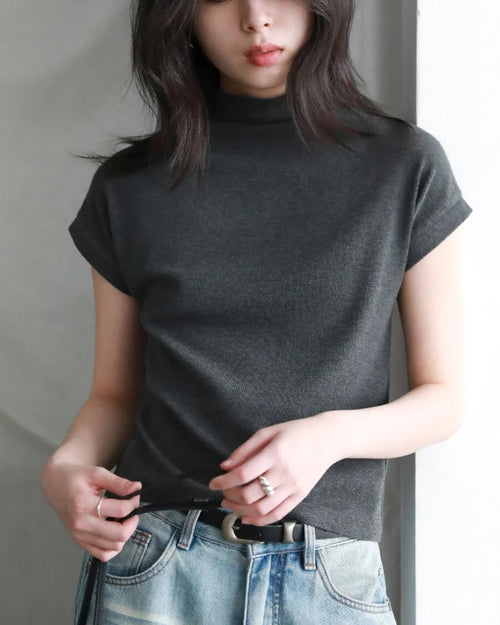 Slim-fit half-high collar knit top in breathable stretch fabric. Elongated silhouette layers effortlessly for city commutes or resort evenings.