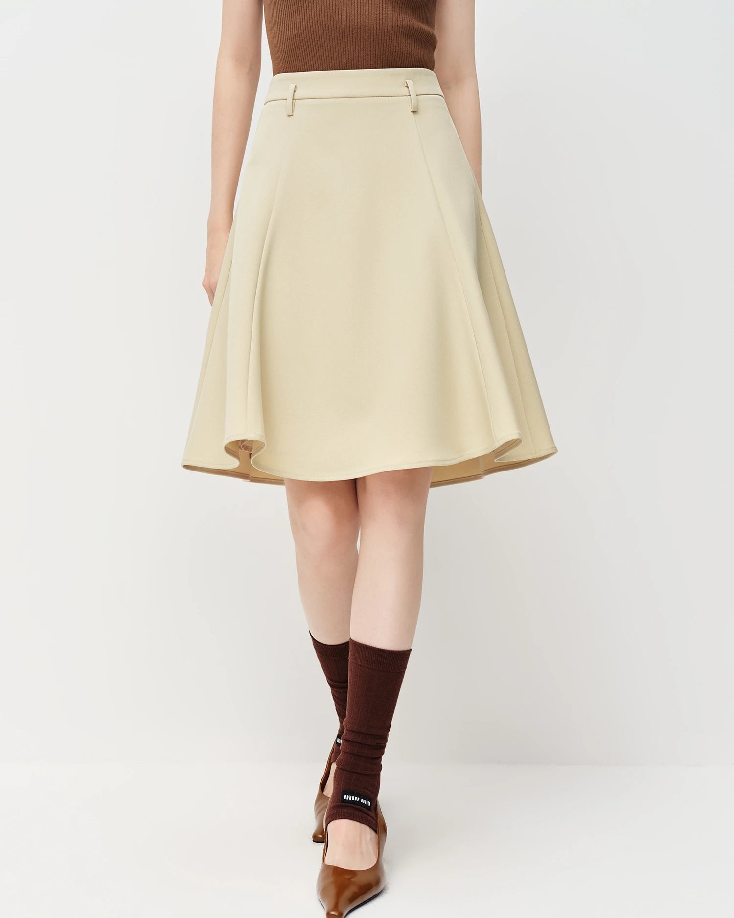 Smooth polyester blend slim-fit A-line zipper knee-length skirt with gentle stretch, offering a polished look perfect for office wear or smart.