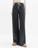 Women's gray high-waisted straight-leg wool-blend pants, featuring a drawstring waist and side pockets for winter office-casual wear or city to resort confidence.