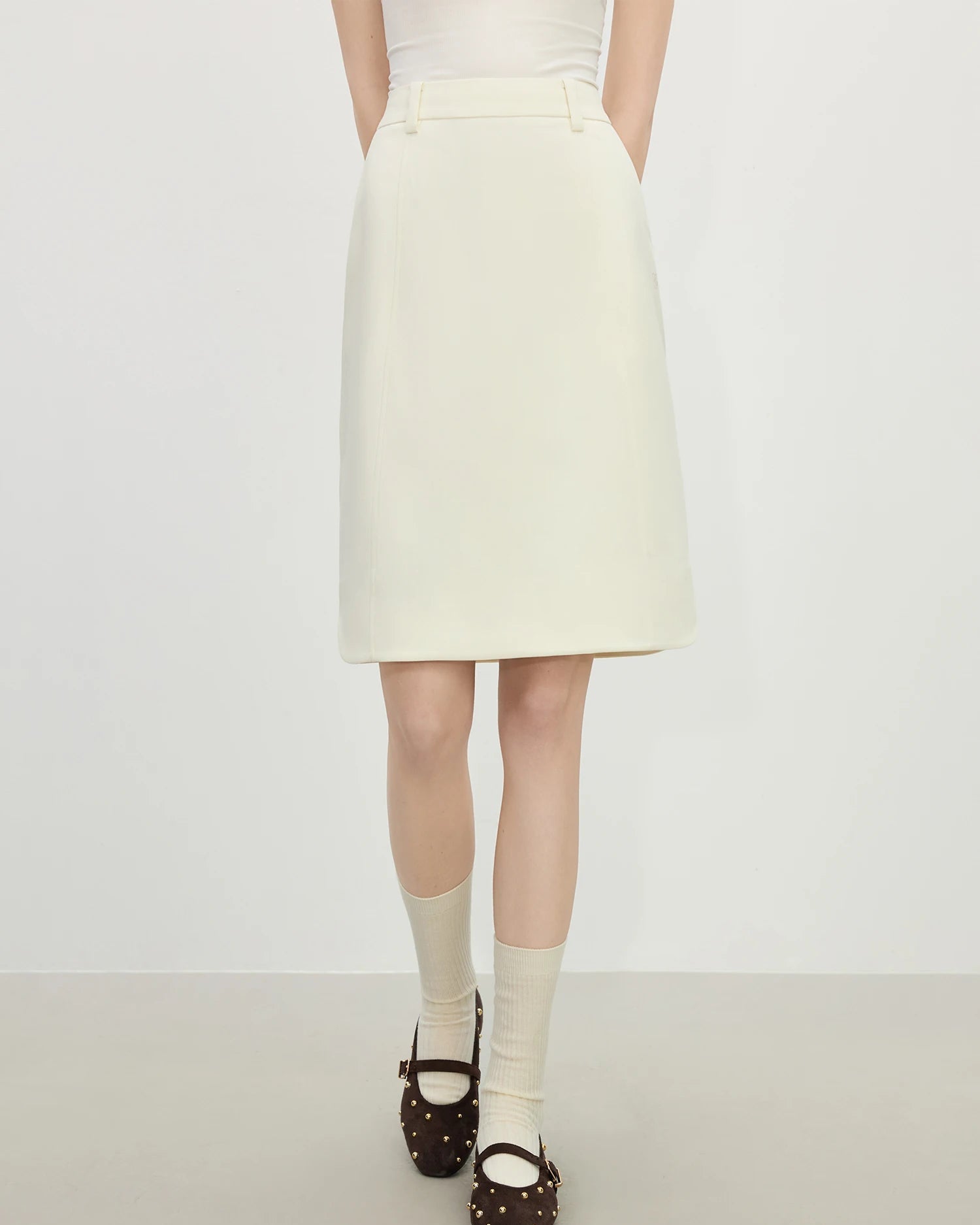 Beige slim-fit straight knee-length skirt crafted from smooth polyester, featuring a minimalist Old Money aesthetic and natural waistline, perfect for polished office wear or casual spring summer outfits.