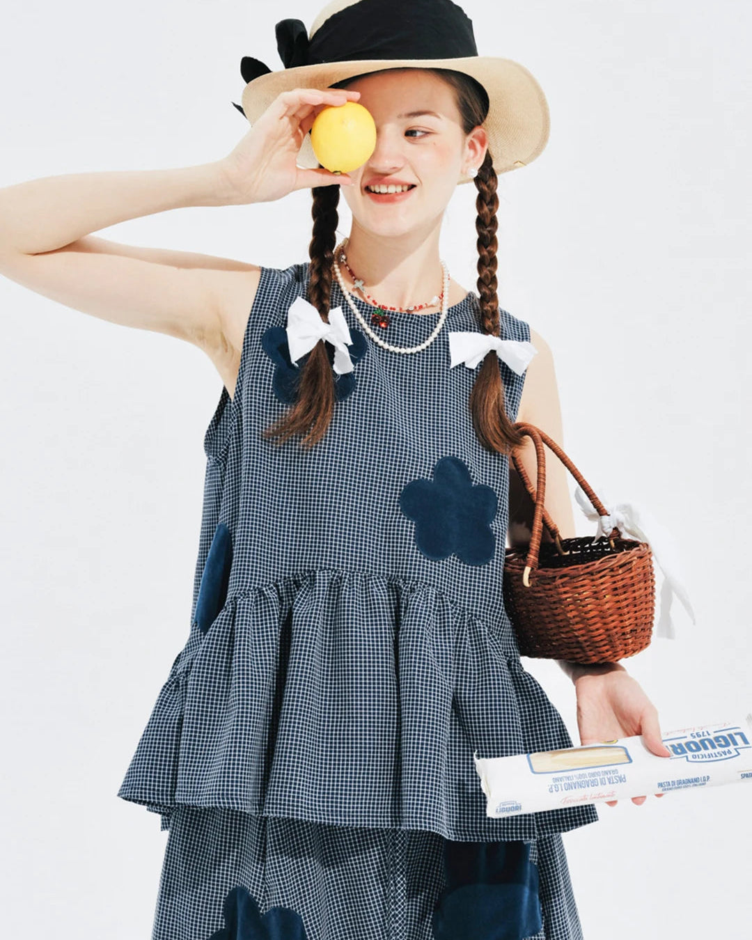 Our Flocked Plaid Knit Vest — a breathable sleeveless summer top with raised appliqué detail and subtle plaid texture. Soft blended fabric, slight stretch.
