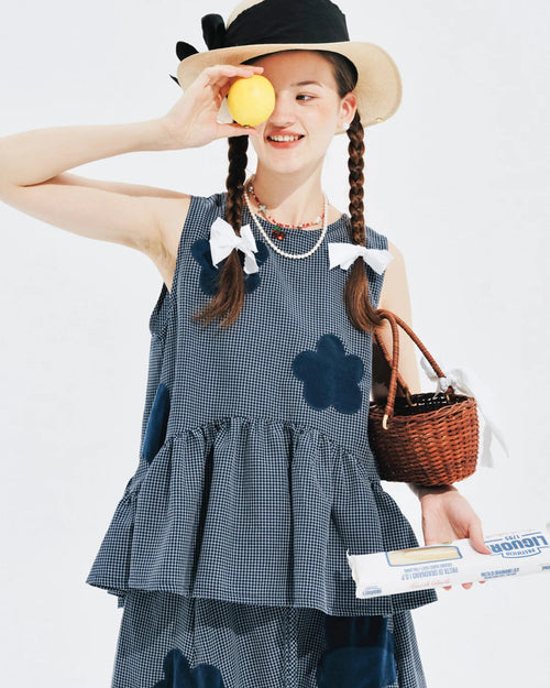Our Flocked Plaid Knit Vest — a breathable sleeveless summer top with raised appliqué detail and subtle plaid texture. Soft blended fabric, slight stretch.
