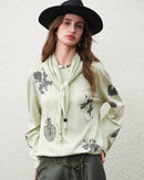 Soft cotton-lyocell-linen blend loose long-sleeved t-shirt featuring a vintage botanical print and round neckline, perfect for breathable office wear or casual spring outfits in light green.