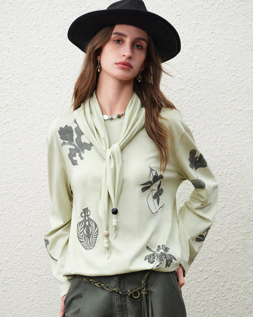 Soft cotton-lyocell-linen blend loose long-sleeved t-shirt featuring a vintage botanical print and round neckline, perfect for breathable office wear or casual spring outfits in light green.