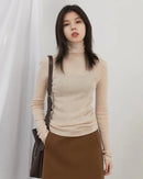 Women's slim-fit turtleneck knit sweater. High-stretch, lightweight blend in black, apricot & coffee. Polished office-ready warmth for fall & winter.