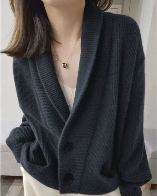 Woman layering a sand-beige Shawl-Collared 100 % Cashmere Cardigan, 19-micron Mongolian fibers and rib-knit shawl collar wrap you in luxe warmth—your breathable 45-65 °F fall-through-spring statement.