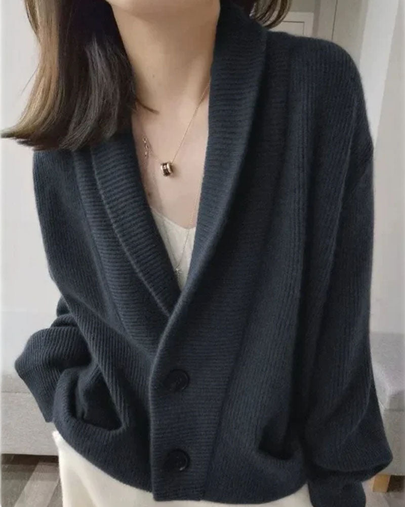 Woman layering a sand-beige Shawl-Collared 100 % Cashmere Cardigan, 19-micron Mongolian fibers and rib-knit shawl collar wrap you in luxe warmth—your breathable 45-65 °F fall-through-spring statement.