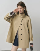 Lightweight sand-beige windbreaker trench jacket with stand collar, zip front and storm flap — spring-ready women’s raincoat by Gentle Herd.