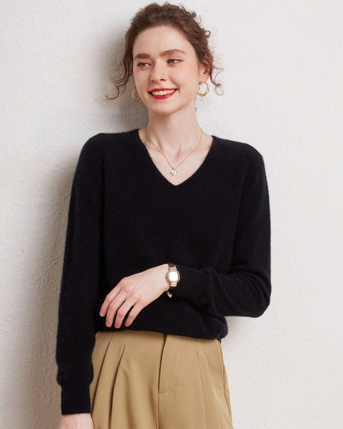 Woman sipping coffee in latte 100 % cashmere v-neck pullover, tightly knitted 2-ply Mongolian fibers drape softly for breathable winter warmth .